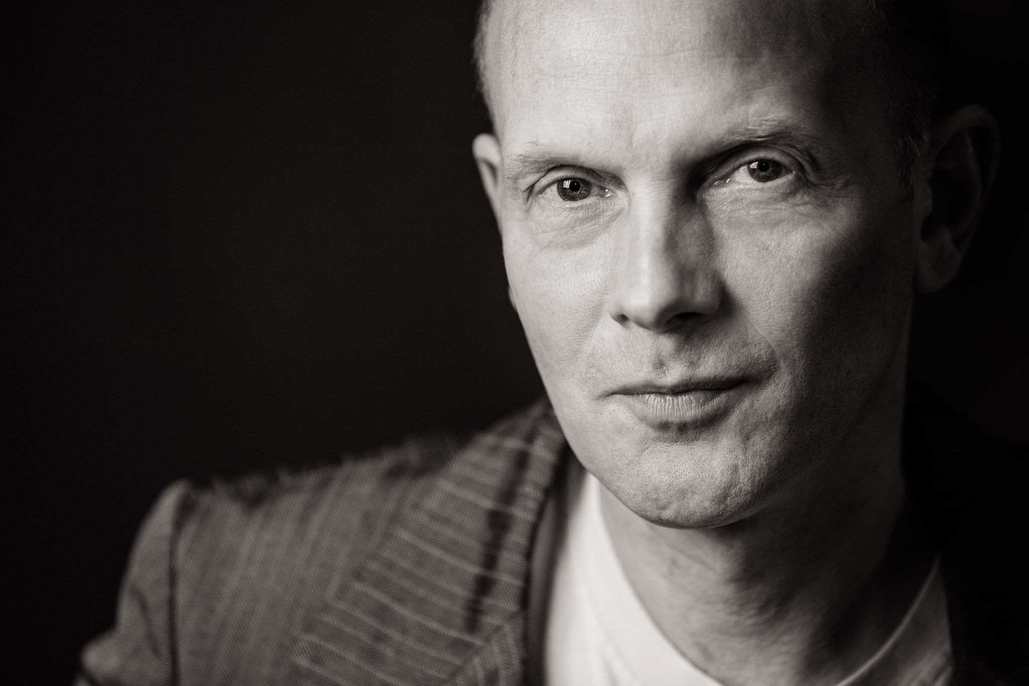 Professional black and white headshot of a man in a suit