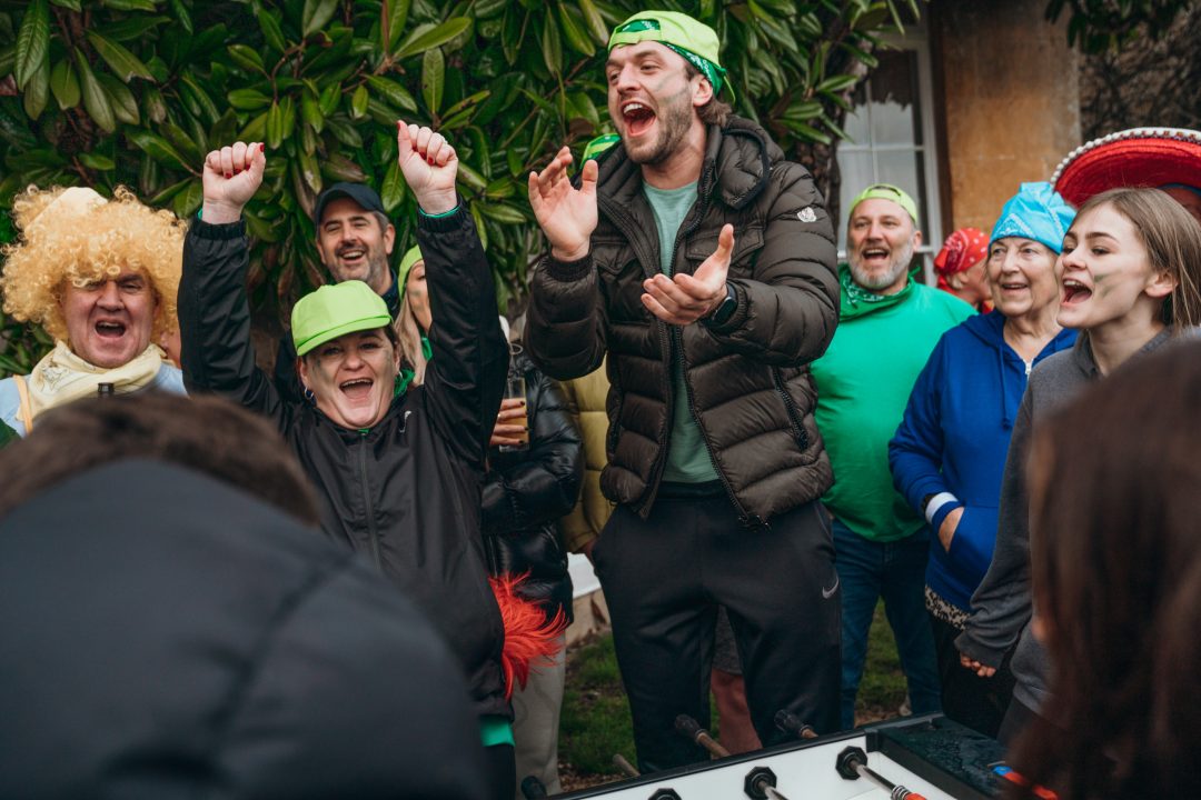 Group cheering during a table football game at a corporate event