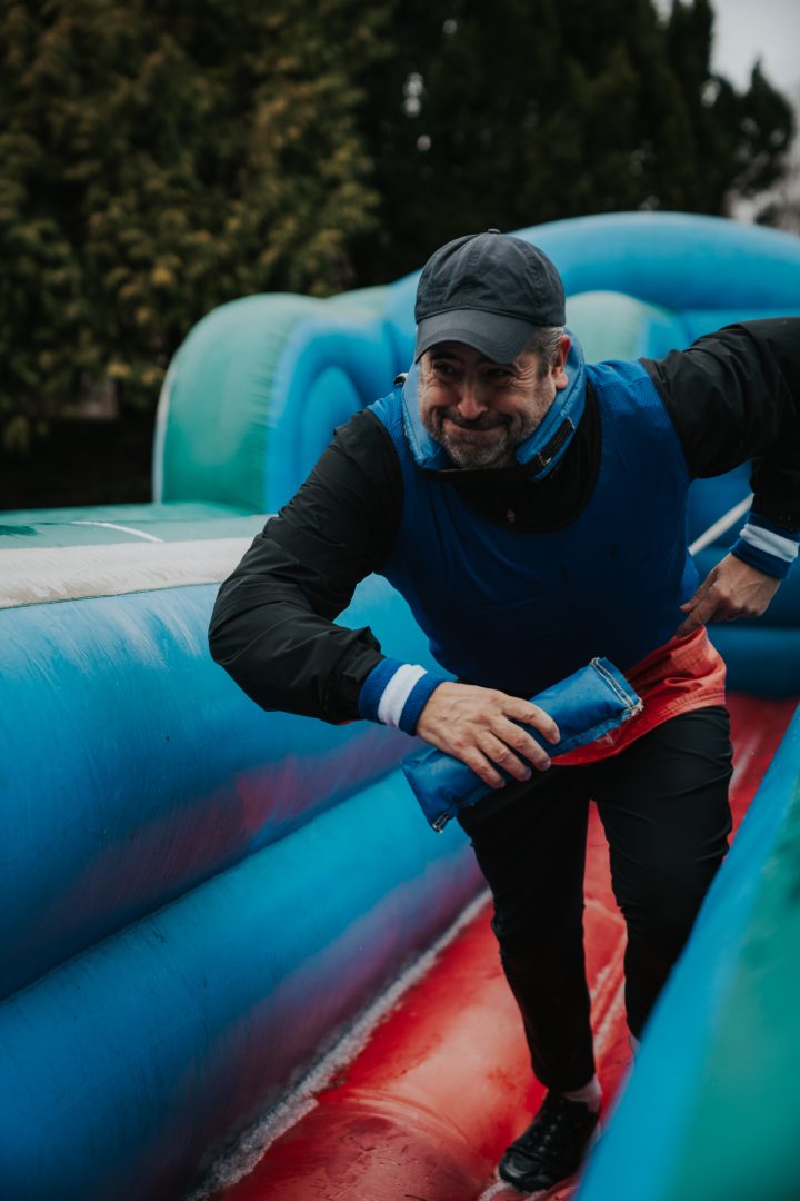 Man running on an inflatable obstacle course at a corporate event