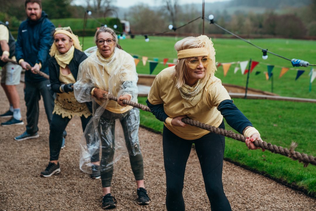 Team of women participating in a tug-of-war game during an event