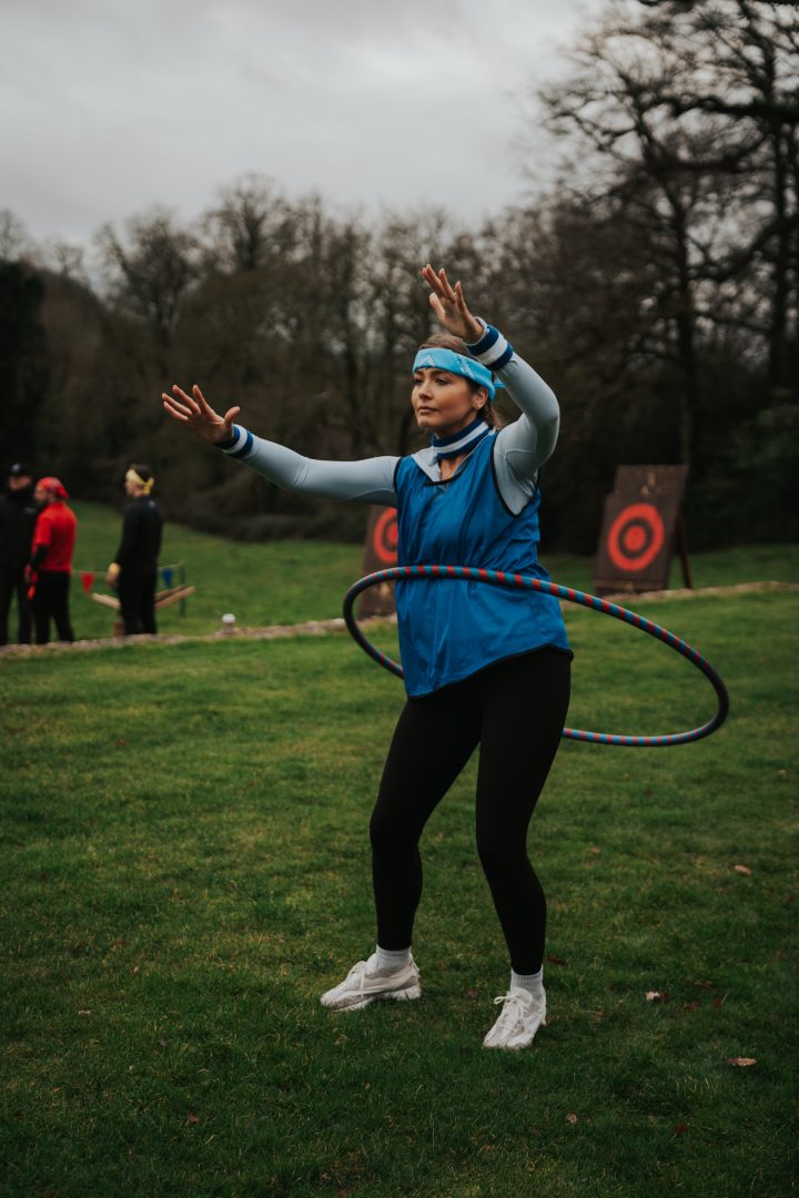 Woman hula-hooping during a corporate team-building activity