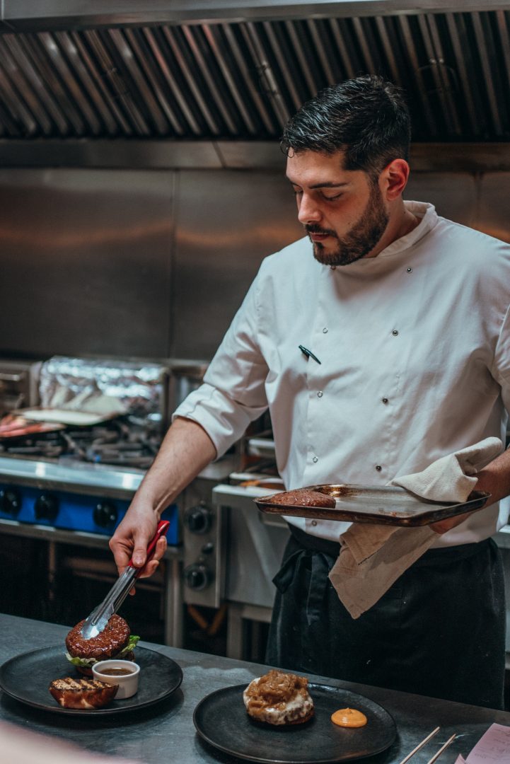Chef preparing a meal in a restaurant kitchen - Branding photography by Sonder Moments Media